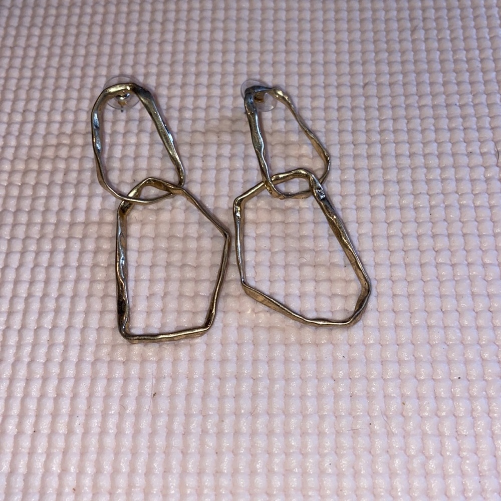 Gold long dangling earrings.